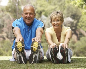 Senior Couple Exercising In Park